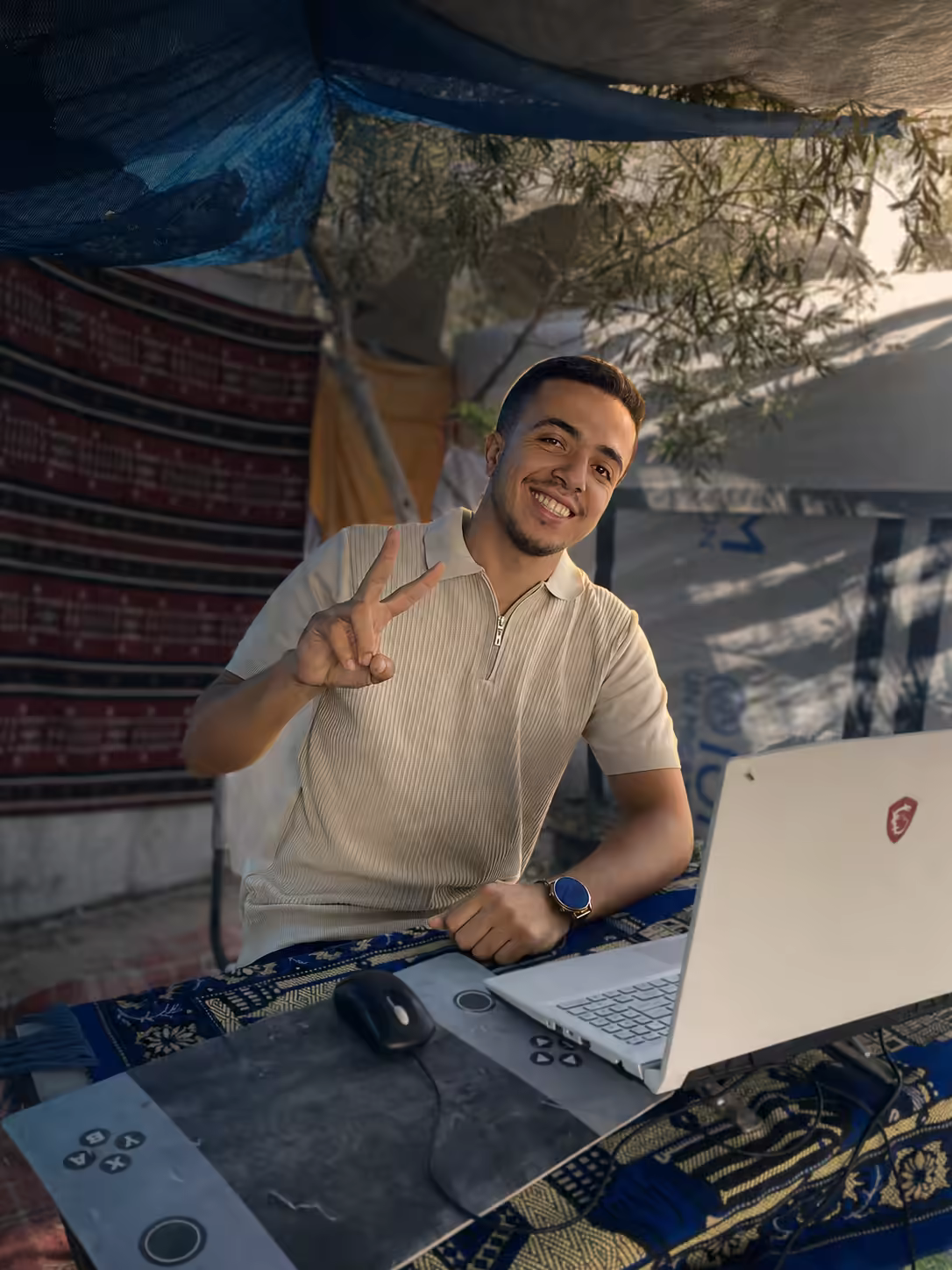 Mohammed Mohammed Al deeb working at a laptop in his authentic working environment